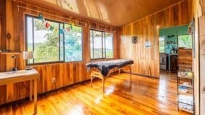 Warm wooden interior of a mountain home with large windows and scenic views.