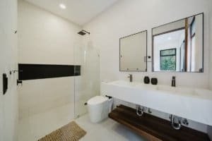 Contemporary bathroom with double sink, large mirror, and walk-in shower in Costa Rica.