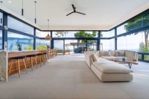 Modern living room with panoramic ocean views and stylish furniture.