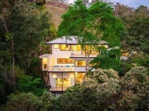 Modern multi-story house surrounded by lush greenery in Dominical, Costa Rica.
