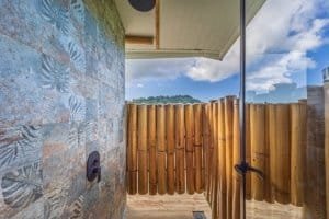 Outdoor shower with mountain views and bamboo fencing in Dominical.