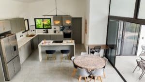 Spacious kitchen with island, dining table, and balcony in Costa Rica.