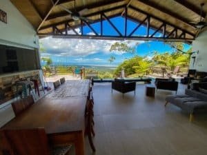 Spacious living area with stunning ocean view and tropical surroundings.