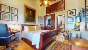 Comfortable bedroom with wooden furniture and tropical decor in Costa Rica.