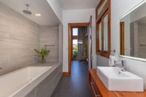 Contemporary bathroom with bathtub, sink, and wooden accents in Costa Rica.
