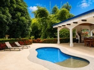 Private villa pool with lush garden and shaded patio in Dominical Costa Rica.