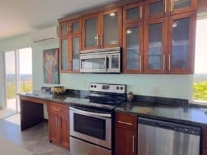 Modern kitchen with wooden cabinets and stainless steel appliances in Dominical.