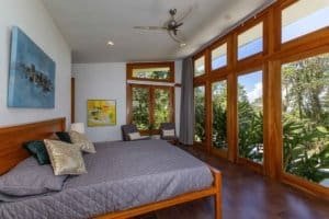 Spacious bedroom with large windows and mountain views in Costa Rica.