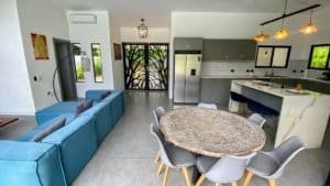 Spacious living room and kitchen in a Costa Rican home with modern decor.