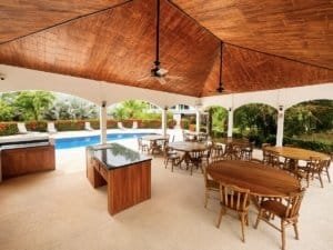 Covered outdoor dining space with wooden tables and chairs in Dominical, Costa Rica.