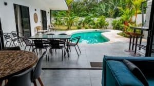 Outdoor pool and patio area with tropical plants in Dominical Costa Rica.