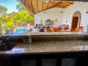 Spacious outdoor living area with ocean view, pool, and lush greenery in Dominical.
