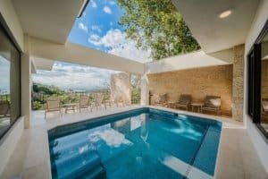 Modern pool area with jungle and ocean view in Costa Rica estate.