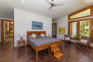 Spacious bedroom with large windows and mountain views in Costa Rica.