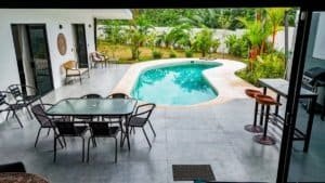 Beautiful backyard with pool, patio, and tropical plants in Dominical, Costa Rica.