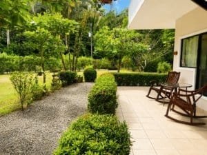Private garden with lush greenery and outdoor seating in Dominical Costa Rica.