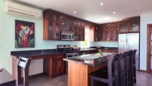 Spacious kitchen with wooden cabinets and granite countertops in Costa Rica.