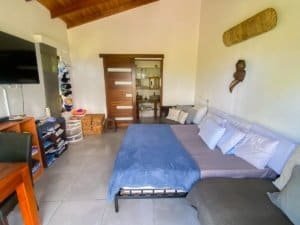 Bedroom with ocean view, modern decor, and wooden accents in Dominical.