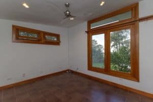 Spacious room with large windows and mountain views in Dominical.