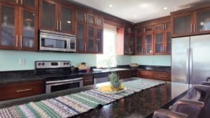 Spacious kitchen with dark wood cabinets and stainless steel appliances in Dominical.