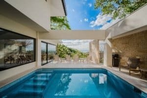 Modern estate pool with jungle and ocean view in Dominical, Costa Rica.