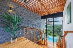 Balcony with mountain view, pool, and modern decor in Costa Rica.