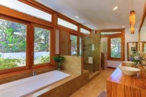 Spacious bathroom with large windows and mountain views in Costa Rica.