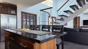 Interior view of a modern Costa Rican home with open living space and staircase.