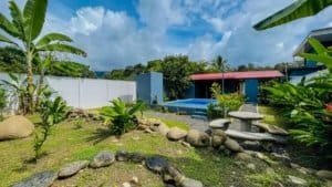 Beautiful backyard with pool, lush greenery, and tropical plants in Costa Rica.