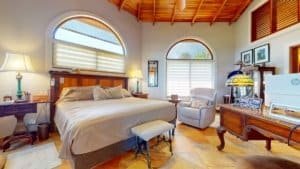 Elegant bedroom with large windows and tropical decor in Costa Rica.
