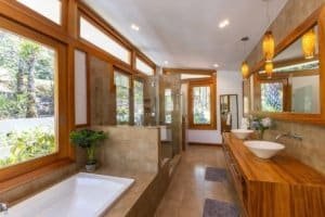 Spacious bathroom with large windows and mountain views in Costa Rica.