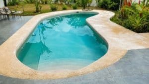 Swimming pool with tropical garden in Costa Rica residential property.