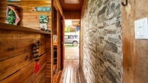Interior view of a mountain home with wooden and stone walls near Nauyaca Waterfalls.