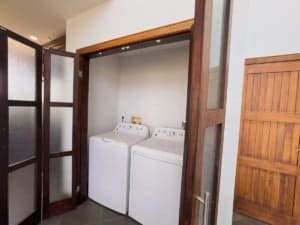 Clean laundry area with washer and dryer in Costa Rica home.