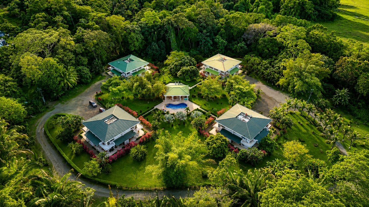 Aerial view of luxury villas in a lush green gated community in Dominical.
