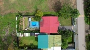 Aerial view of a charming Costa Rican home with a private pool and lush garden.