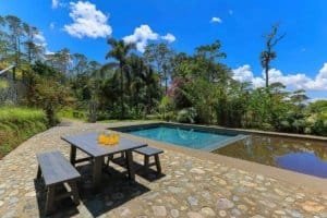 Pool with mountain view and outdoor dining area in Dominical.