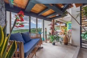 Balcony with mountain views, plants, and cozy seating in Dominical.