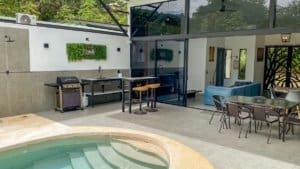 Contemporary indoor living area with pool, dining, and seating in Dominical.