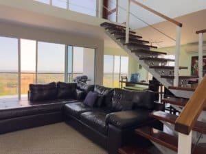 Spacious living room with panoramic ocean and mountain views in Dominical.