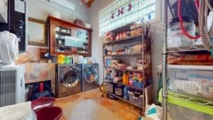 Interior storage room with shelves, washer, and household items in Costa Rica.