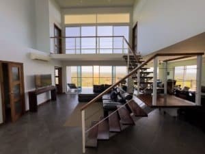 Spacious living room with large windows and panoramic views in Dominical.