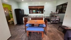 Interior of a modern kitchen with dining table and appliances in Dominical.