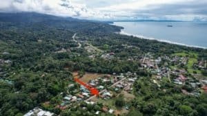 Aerial view of Dominical coastline, lush greenery, and ocean in Costa Rica.