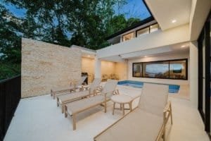 Modern Costa Rica estate with pool, lounge chairs, and jungle view.