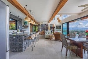 Modern kitchen and dining area with mountain views in Costa Rica.