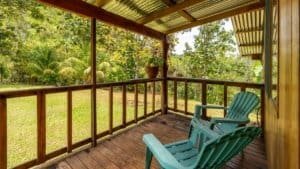 Covered porch with chairs overlooking lush tropical forest in Costa Rica.