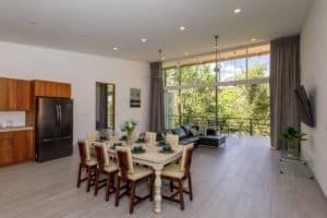 Spacious living room with large windows and mountain scenery in Dominical.