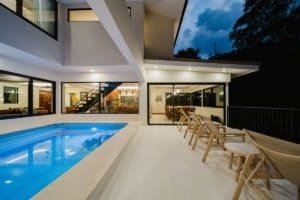 Modern Costa Rican estate with pool, outdoor seating, and jungle view.