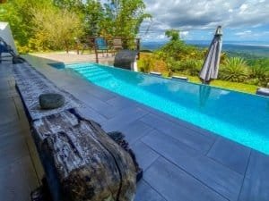 Luxury pool with ocean view and lush landscape in Dominical.
